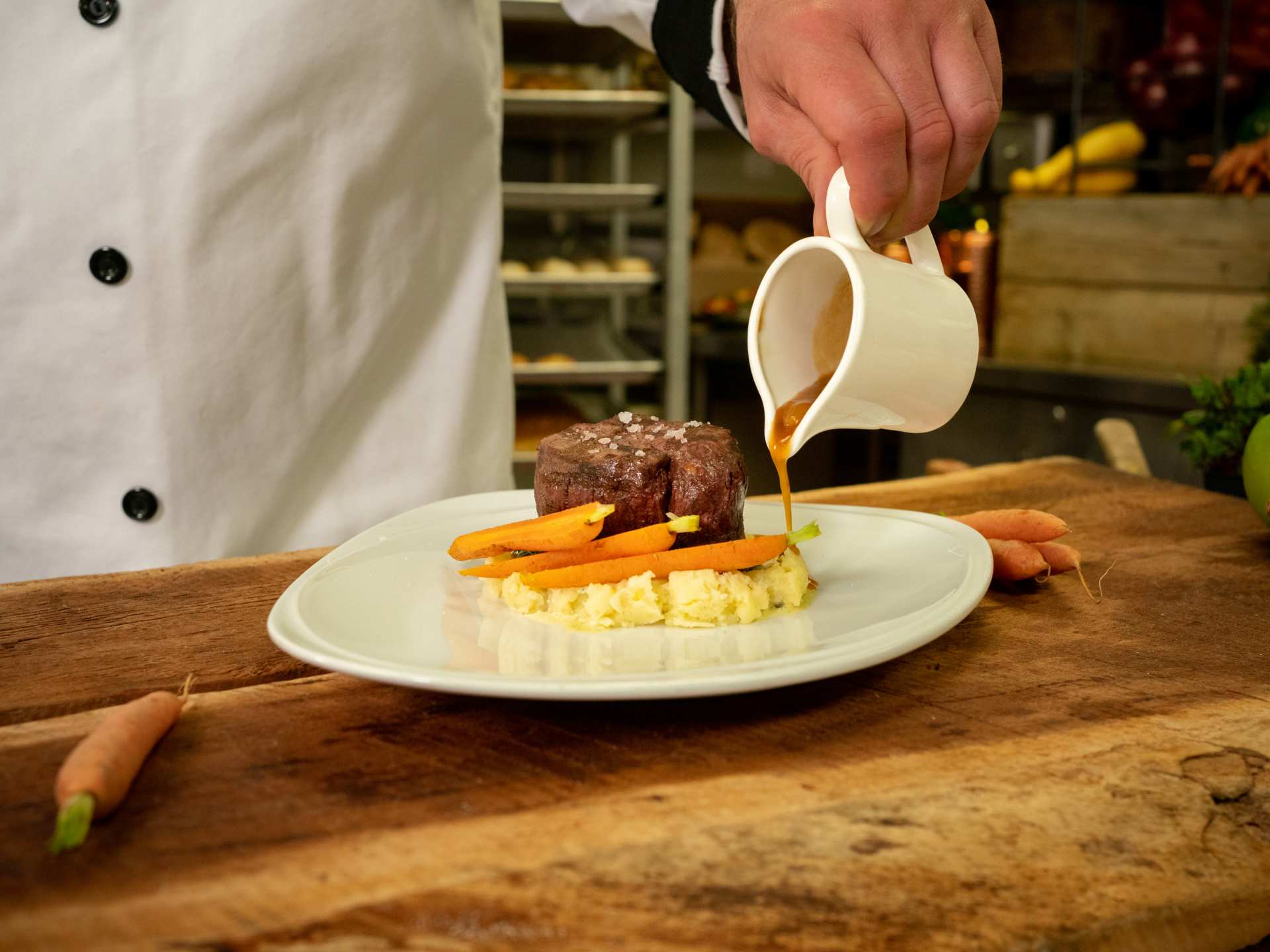 Niagara Park | A chef pours gravy onto a dish at Table Rock House Restaurant