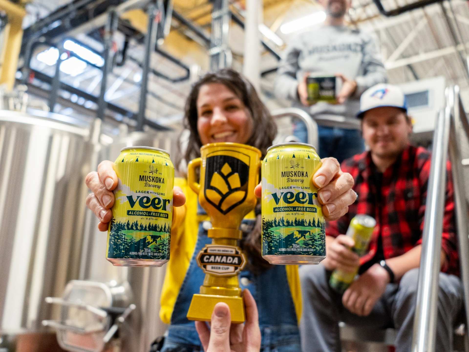 Brewers holding Veer non-alcoholic beer at Muskoka Brewery