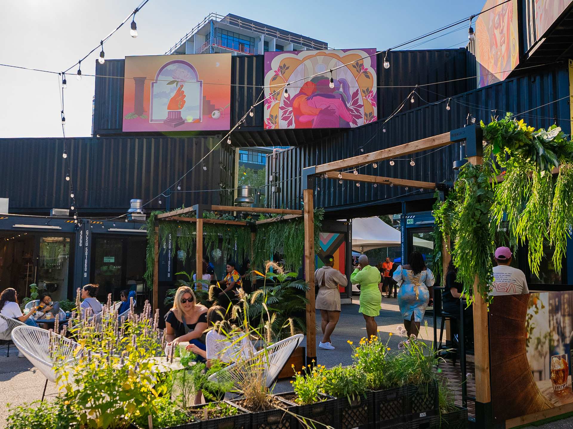 The best patios in Toronto | Stackt's patio with string lights and guests enjoying the weather