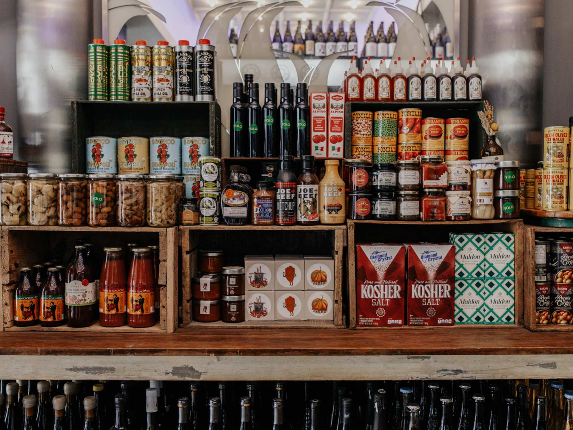 Toronto bottle shops and alcohol stores | Cans, jars and other pantry items on shelves at Bottega Volo in Littly Italy, Toronto
