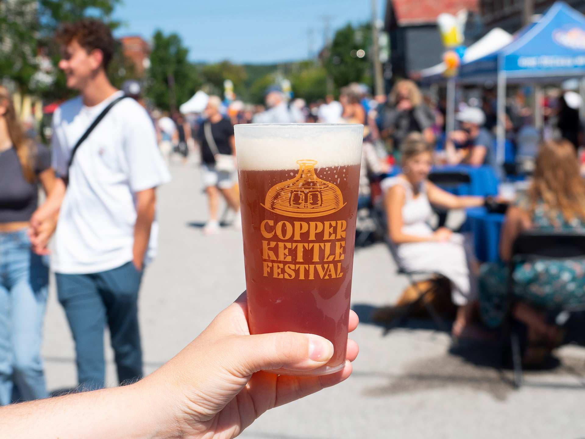 Holding a pint of beer at Copper Kettle Festival in Creemore, Ontario