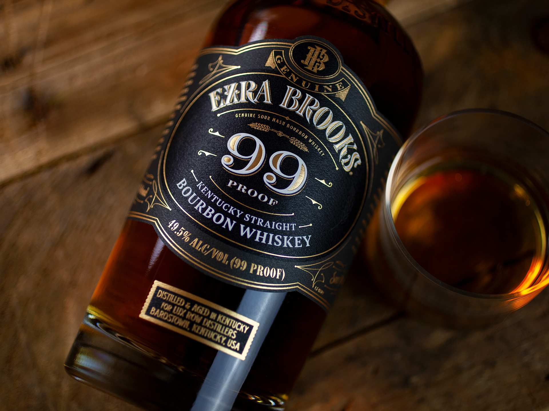 A bottle of Ezra Brooks 99 and a glass of bourbon