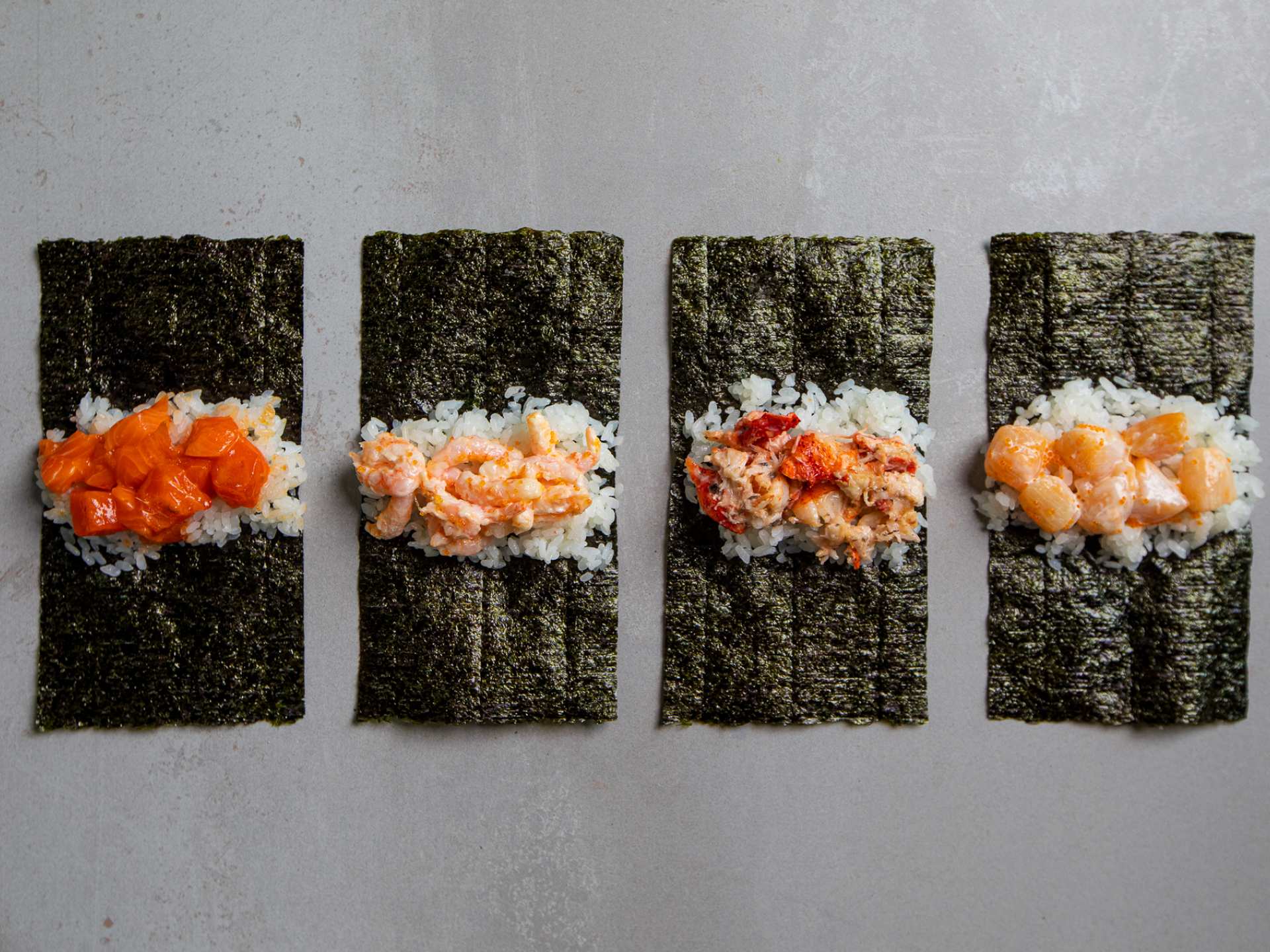 Hello Nori the Hand Roll Bar | Four handrolls lay unwrapped at Hello Nori