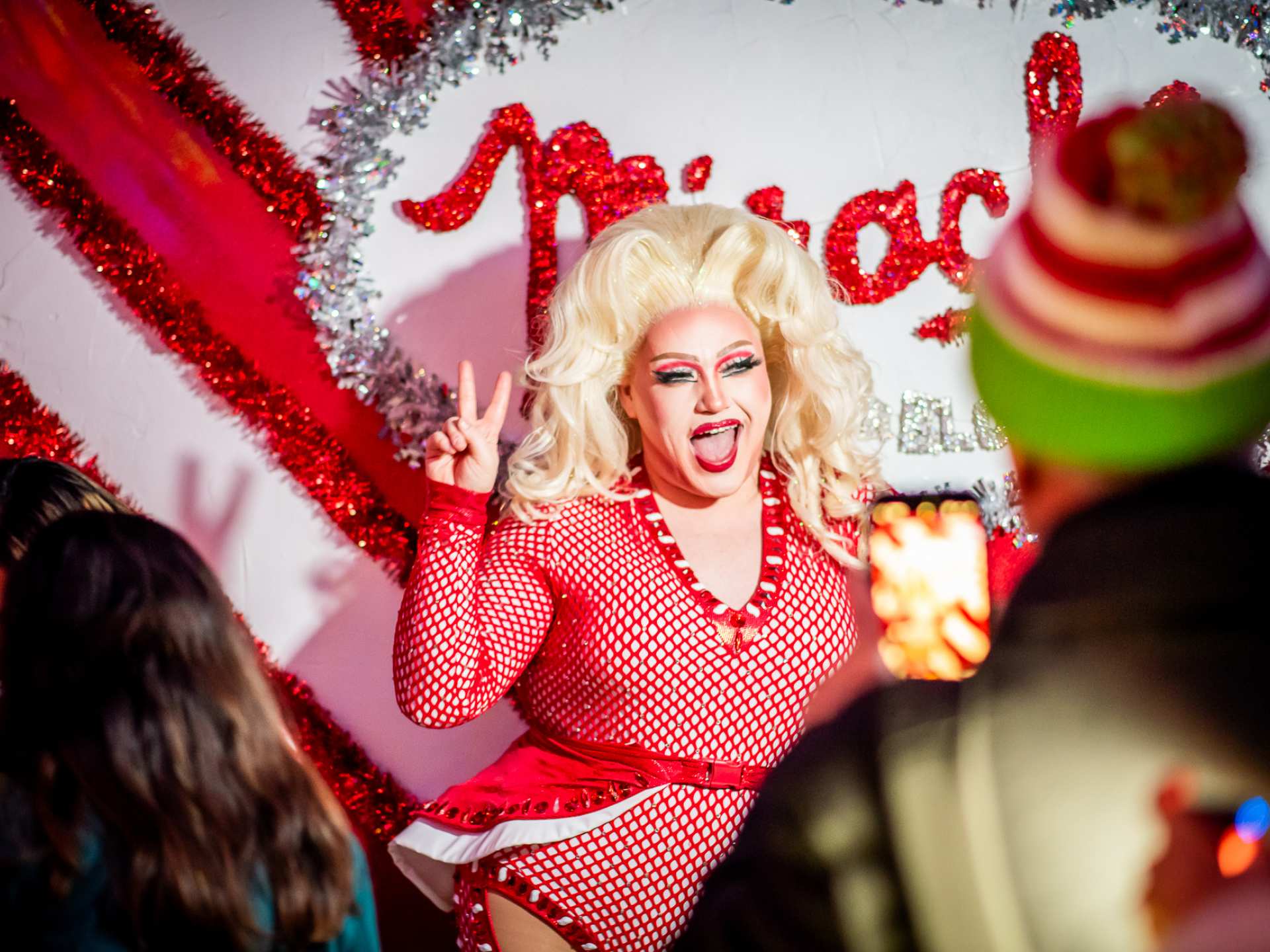 Best Christmas bars and markets in Toronto | A drag queen poses for a picture at Miracle Toronto Christmas Bar