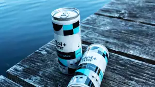 Stel and Mar white wine in a can on the dock at the cottage