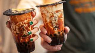 The best bubble tea in Toronto | two people holding brown sugar milk teas from Tiger Sugar