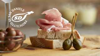 Prosciutto di San Daniele on bread with olives