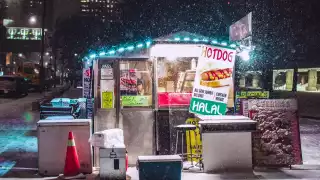 Things to do in Toronto this January 2021 | Snow falls on a hot dog stand beside Nathan Phillips Square