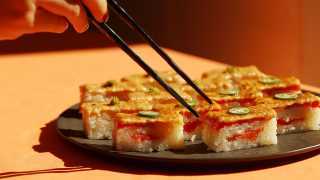 Sushi types and how to eat sushi | Chopsticks reach for a platter of salmon oshi at Minami Toronto
