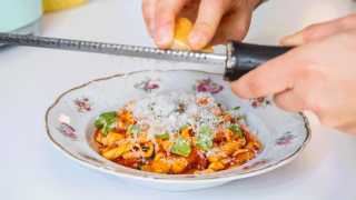 Toronto home cooks and their online food businesses | Jess Maiorano of Pasta Forever grating cheese over pasta