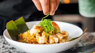 Toronto home cooks and their online food businesses | Wesley Altuna garnishing a dish from Bawang