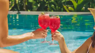Picnic recipes | People cheers by the pool with two select spritzes