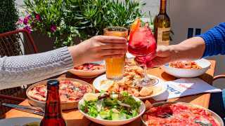 The best patios in Toronto | Two people cheers at Il Patio di Eataly with Aperol