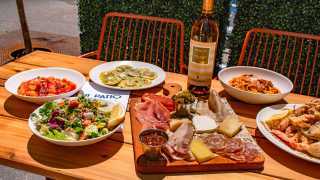 The best patios in Toronto | A spread of dishes at Il Patio di Eataly with Aperol