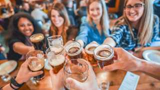 Celebrate International Beer Day with American craft beer | A group celebrating with pints