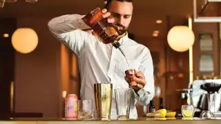 A bartender mixing cocktails with Daydream sparkling water