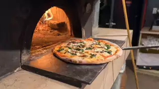 Cellar Door Restaurant | A pizza going into the oven