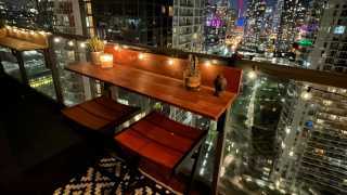Win an acacia wood Views Balcony Bar | A Views Balcony Bar at night