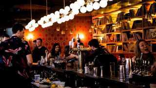 Estrella Damm Culinary Journey | People drinking at the bar at Mrs. Robinson