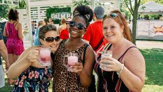 Three people hold up their drinks at Fizz Fest