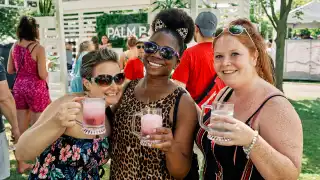 Three people hold up their drinks at Fizz Fest