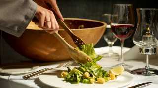 Accessible restaurants in Toronto | A caesar salad tossed table-side at Hy's steakhouse