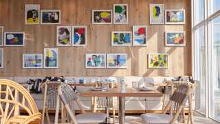 Accessible restaurants in Toronto | Art prints decorate the walls inside KŌST