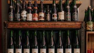 Bottega Volo | Wine bottles lined up on a shelf at Bottega Volo
