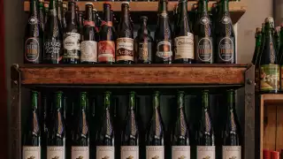 Bottega Volo | Wine bottles lined up on a shelf at Bottega Volo
