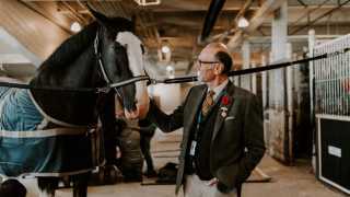 Q&A with Michael Bonacini | Michael Bonacini pets a horse at the The Royal Agricultural Winter Fair
