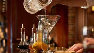 Toronto's best steakhouses | A bartender pours a martini at Hy's Steakhouse & Cocktail Bar