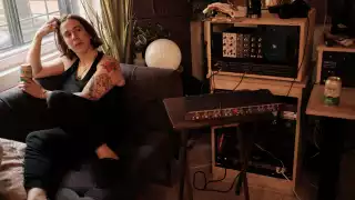 Serena Ryder sitting in her home studio with a can of Libra non-alcoholic beer