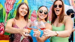 Three people enjoying glasses of wine at Wine Fest Toronto