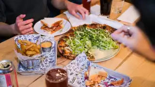 Toronto bottle shops and alcohol stores | Hands picking over an assortment of dishes at Left Field Brewery, Liberty Village, Toronto