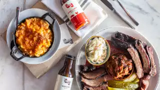 Shop Carbon Bar | A spread of mac and cheese, BBQ meats and sauce