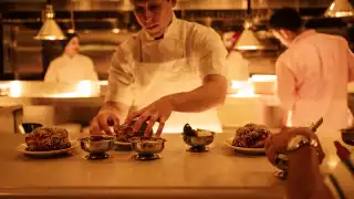 Linny's | Chef David Schwartz plates challah bread at the chef's pass at Linny's