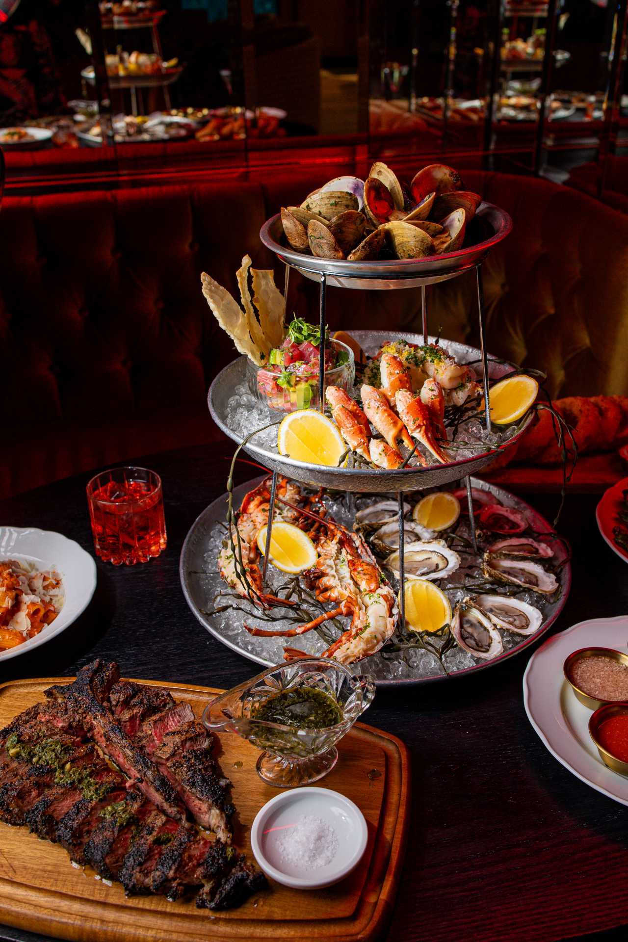 A seafood tower and a steak at Maxime's restaurant in Toronto