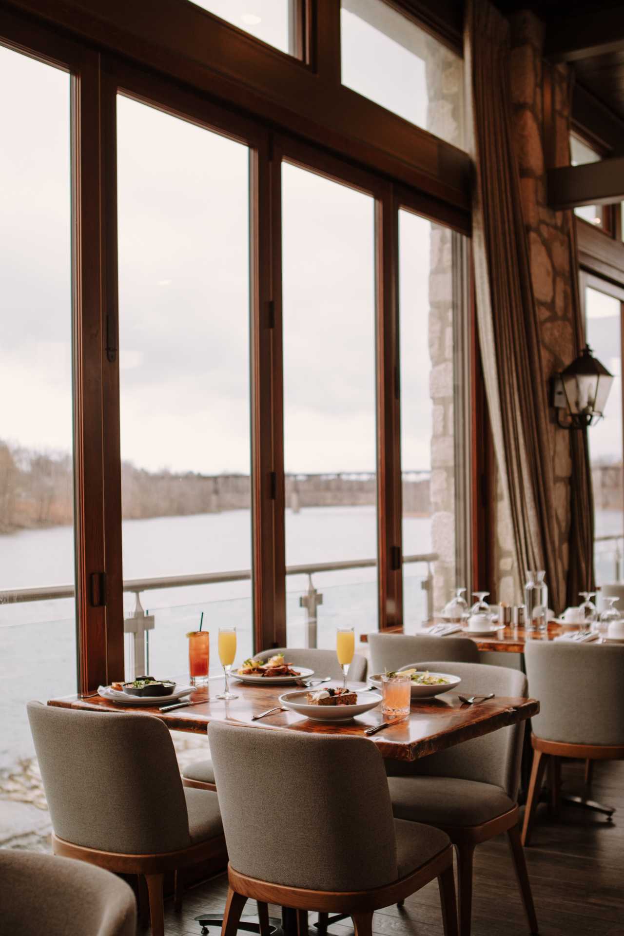 Cambridge Mill | A brunch spread on a table with a view of the Grand River