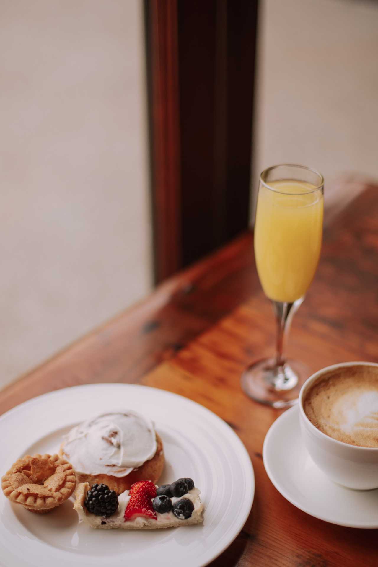 Cambridge Mill | A mimosa, plate of desserts and a coffee at the Cambridge Mill brunch