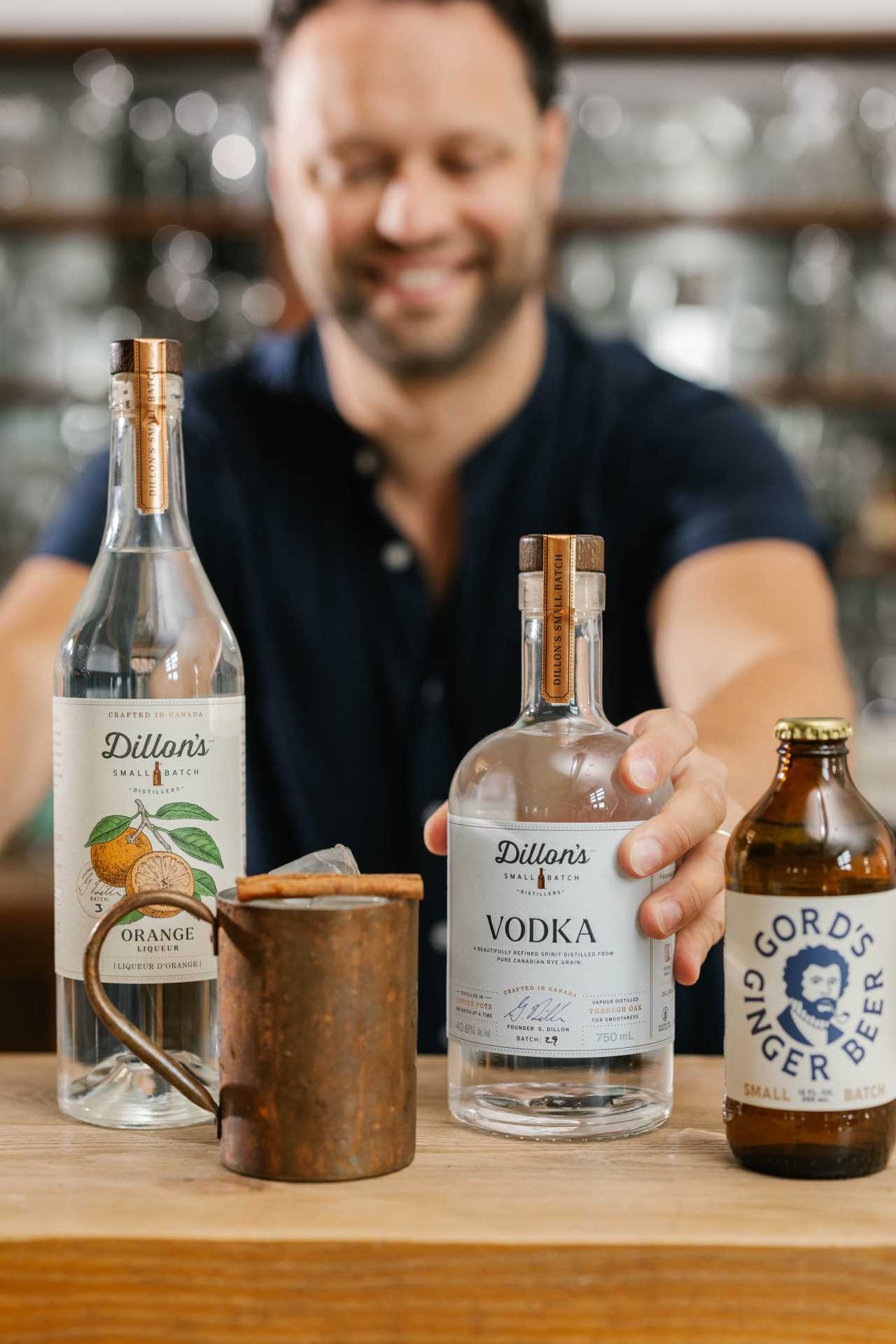 A bartender makes a moscow mule using Dillon's Vodka