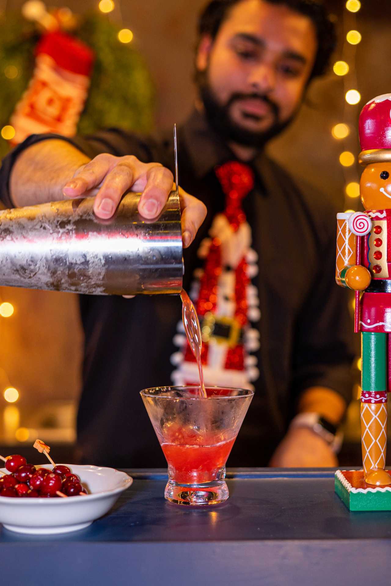 Best Christmas bars and markets in Toronto | A bartender pours a cocktail inside Ginger's Cocktail Bar