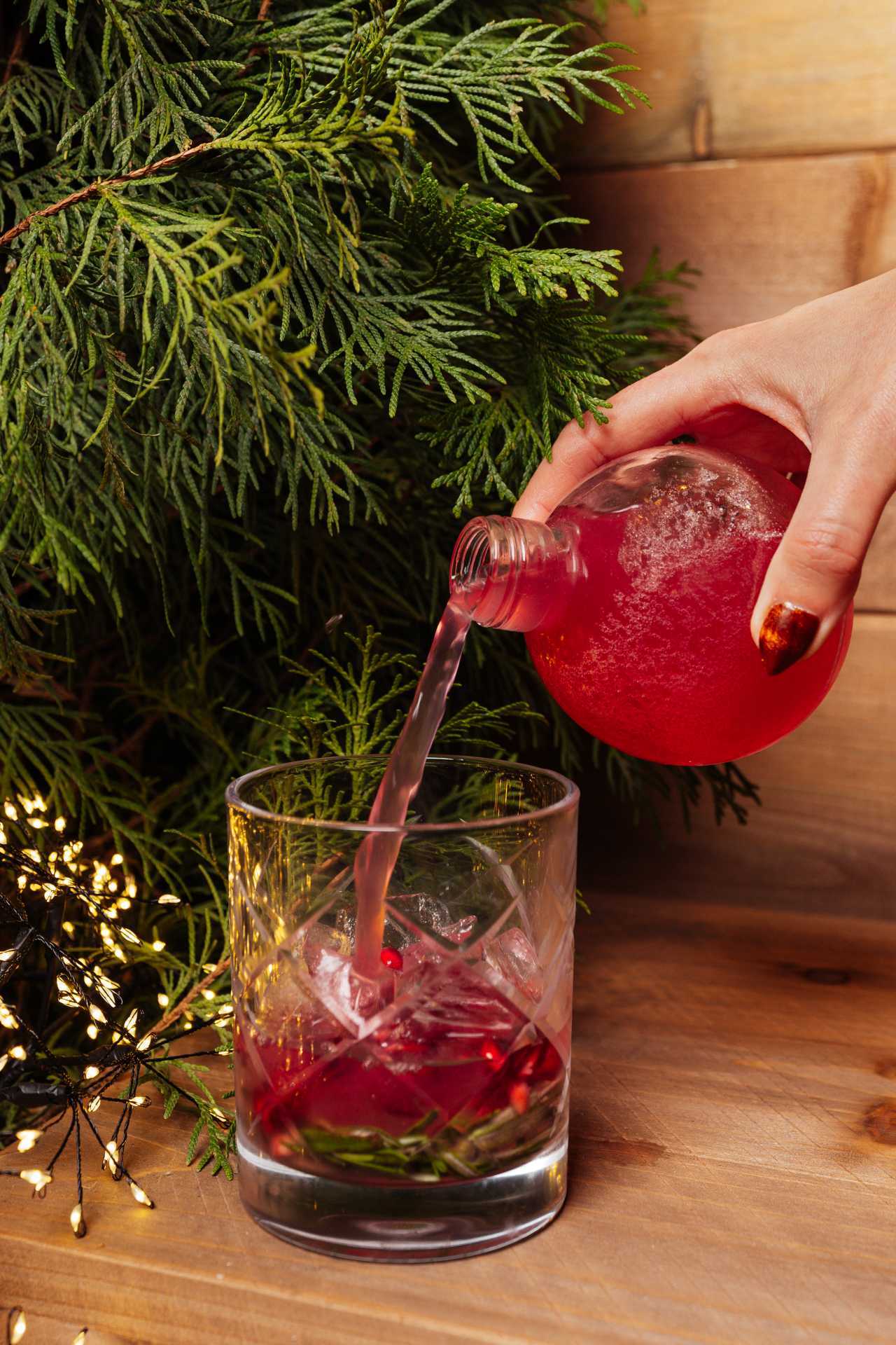 Christmas bars and markets in Toronto | Pouring a cocktail from a Christmas ornament at KŌST Chalet in Toronto