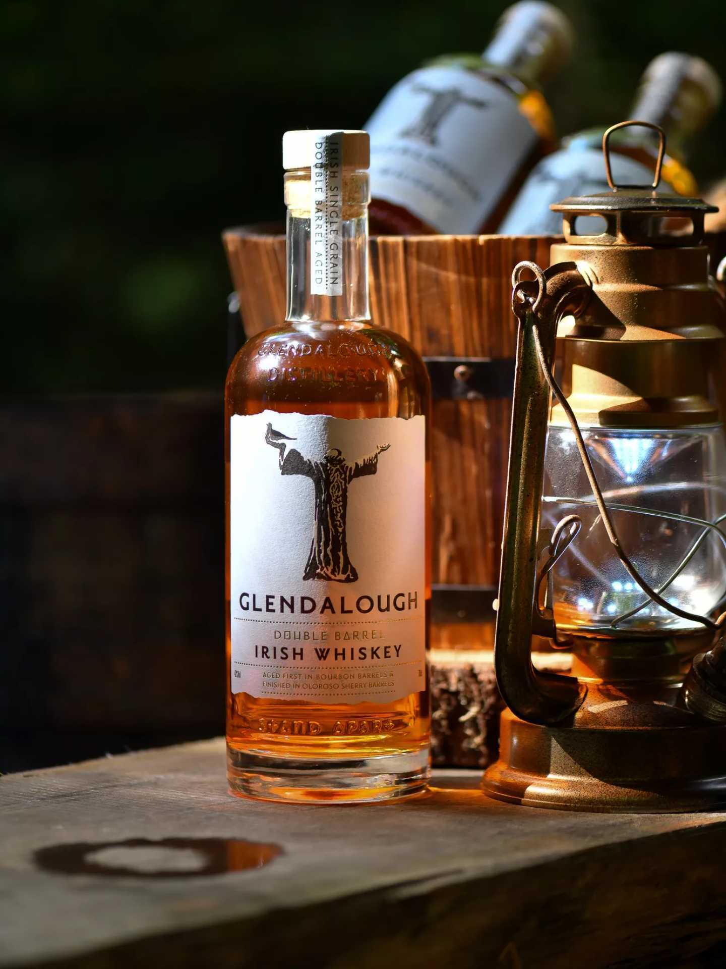 A bottle of Glendalough Double Barrel Irish Whiskey with a lantern