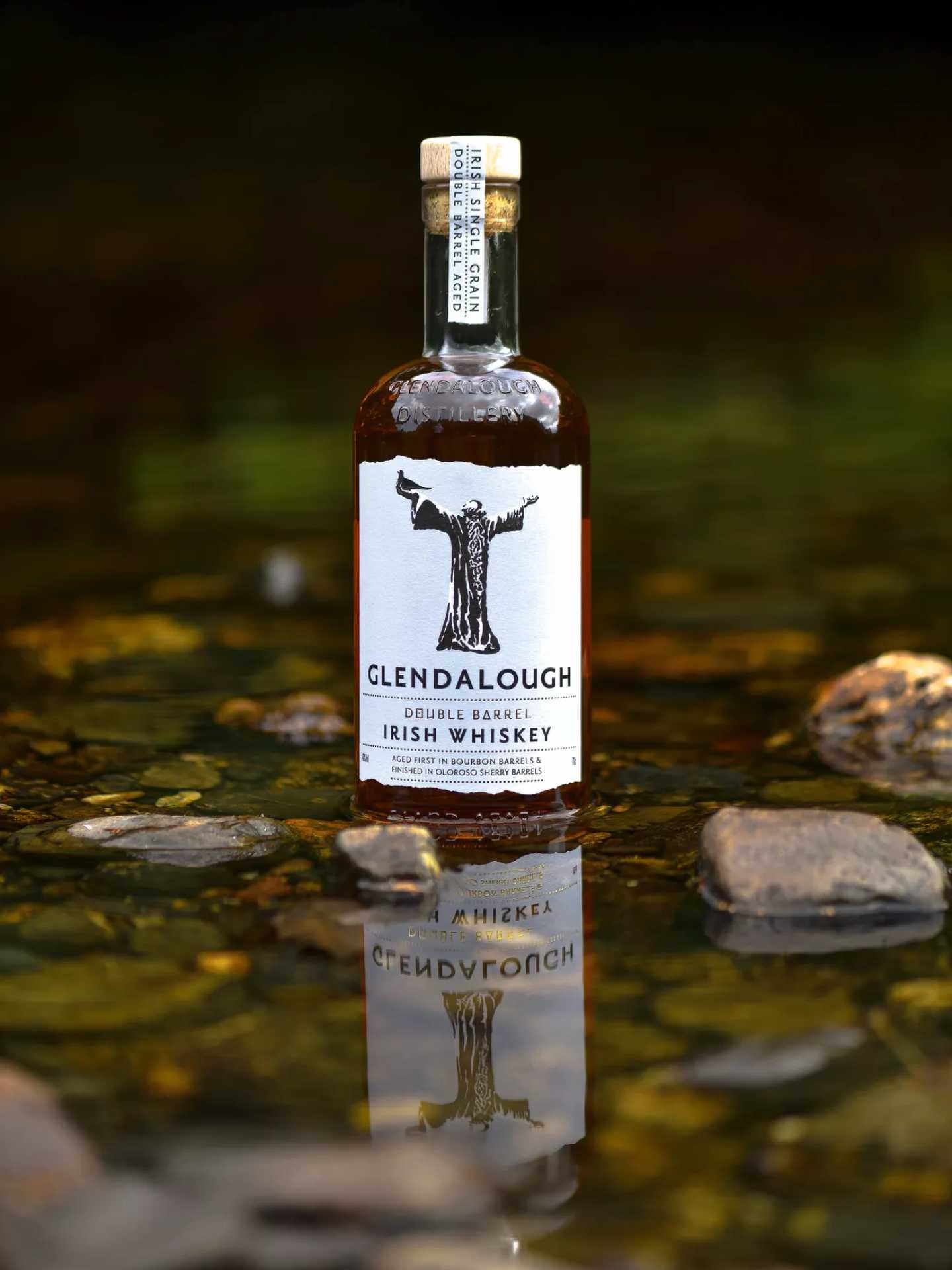 A bottle of Glendalough Double Barrel Irish Whiskey in a pond