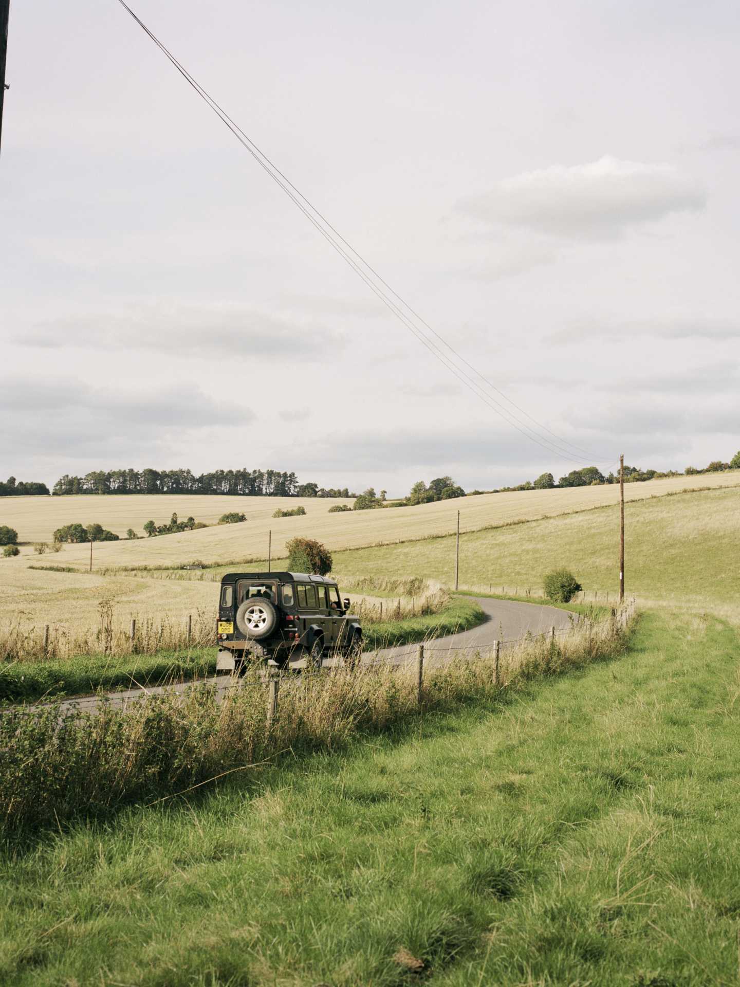 A car driving through the countryside at Ramsbury Distillery