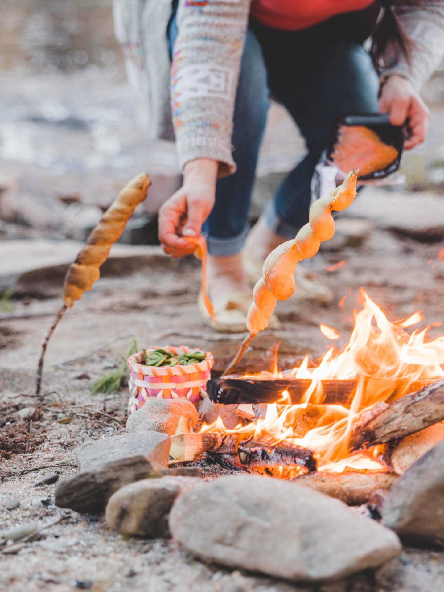 Indigenous food experiences in Canada | Jenna White cooks bannock over the fire