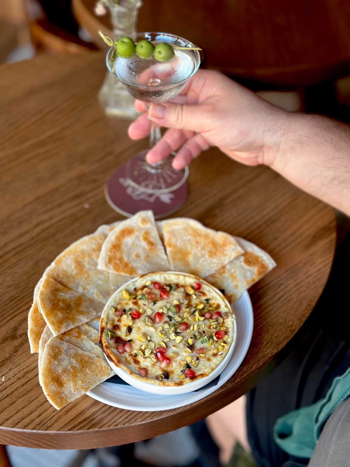 Best new restaurants Toronto | A colourful dip with pita bread, paired with a martini at Wolfie
