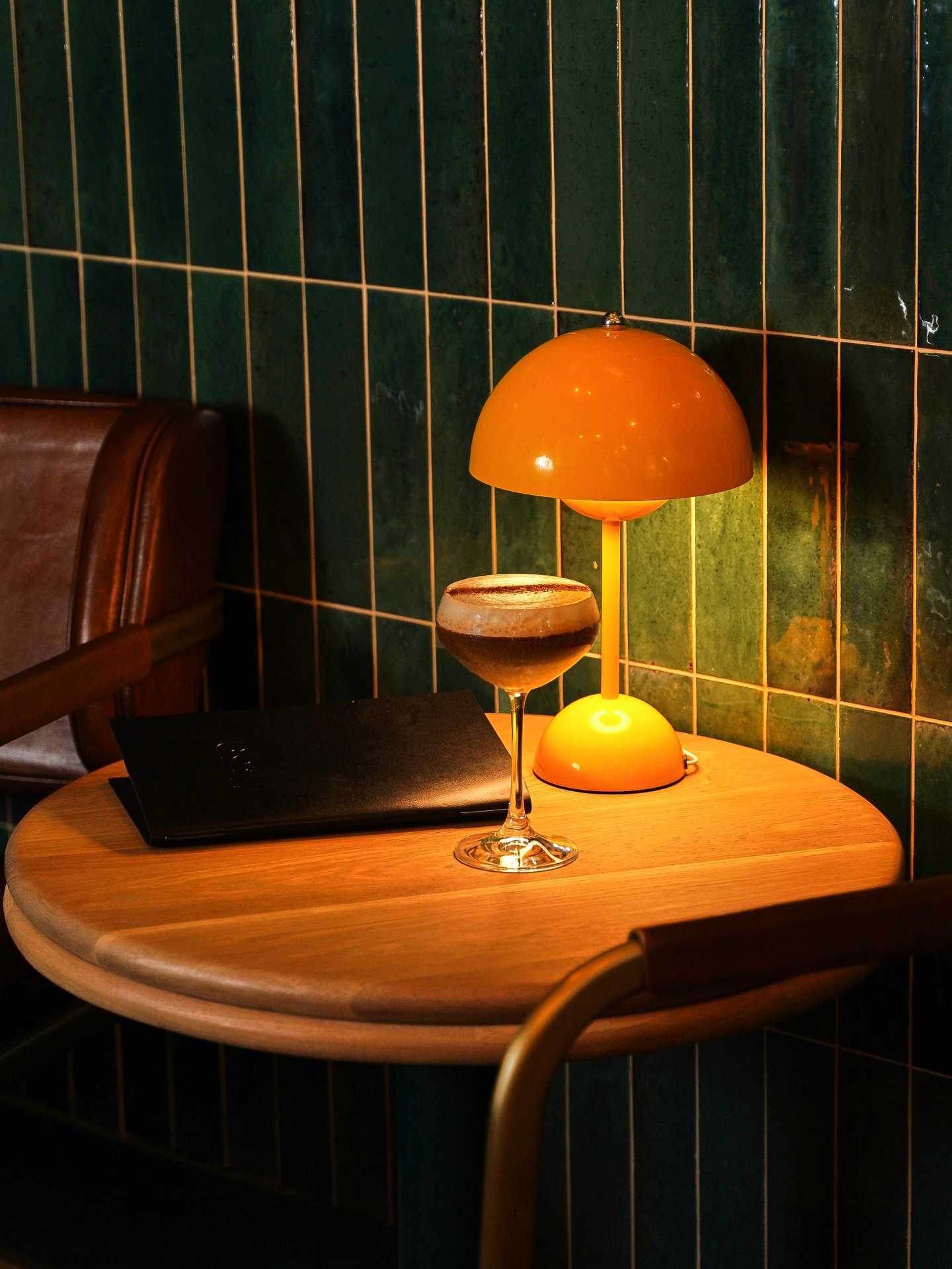 An espresso martini on a wooden table at 11:59 Bar:Café