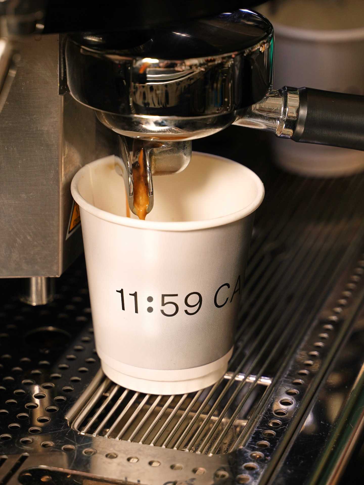 Pouring a cup of coffee at 11:59 Bar:Café