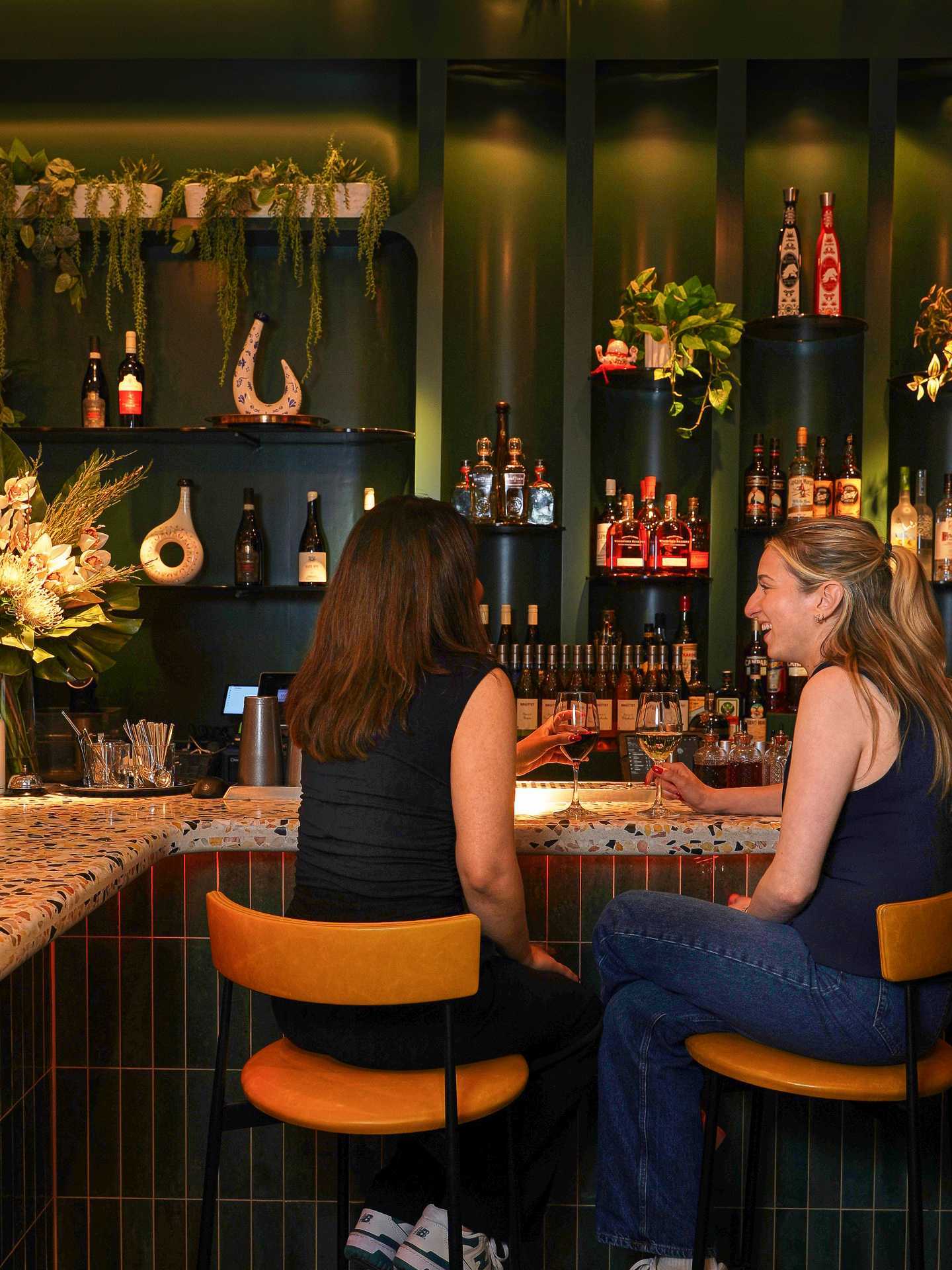 Two people enjoying cocktails at the bar at 11:59 Bar:Café